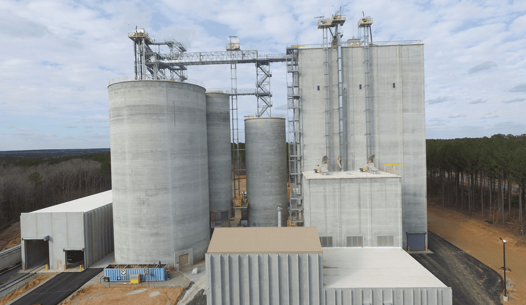 Industrial silo complex under cloudy sky