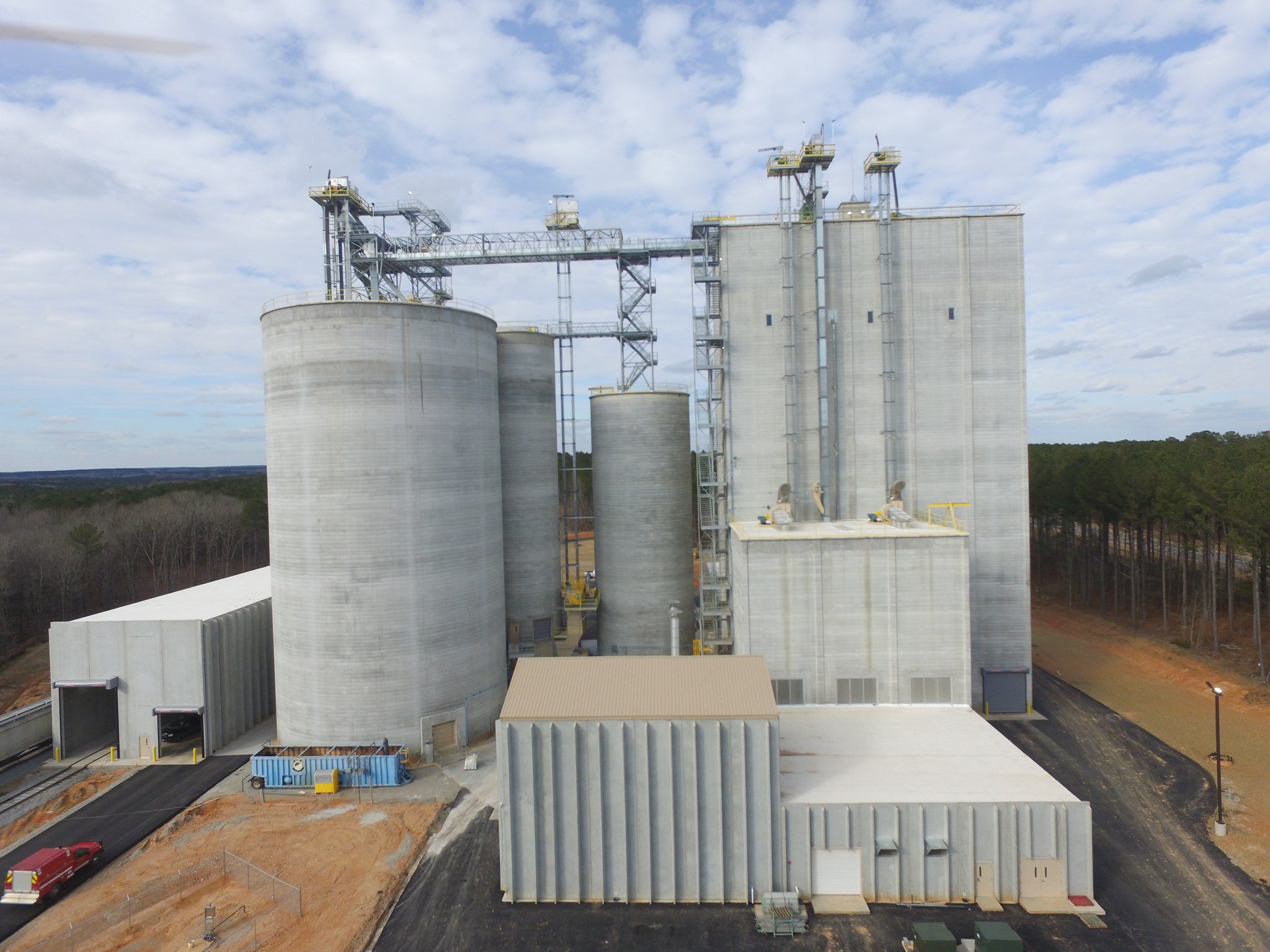 Industrial silos under cloudy sky