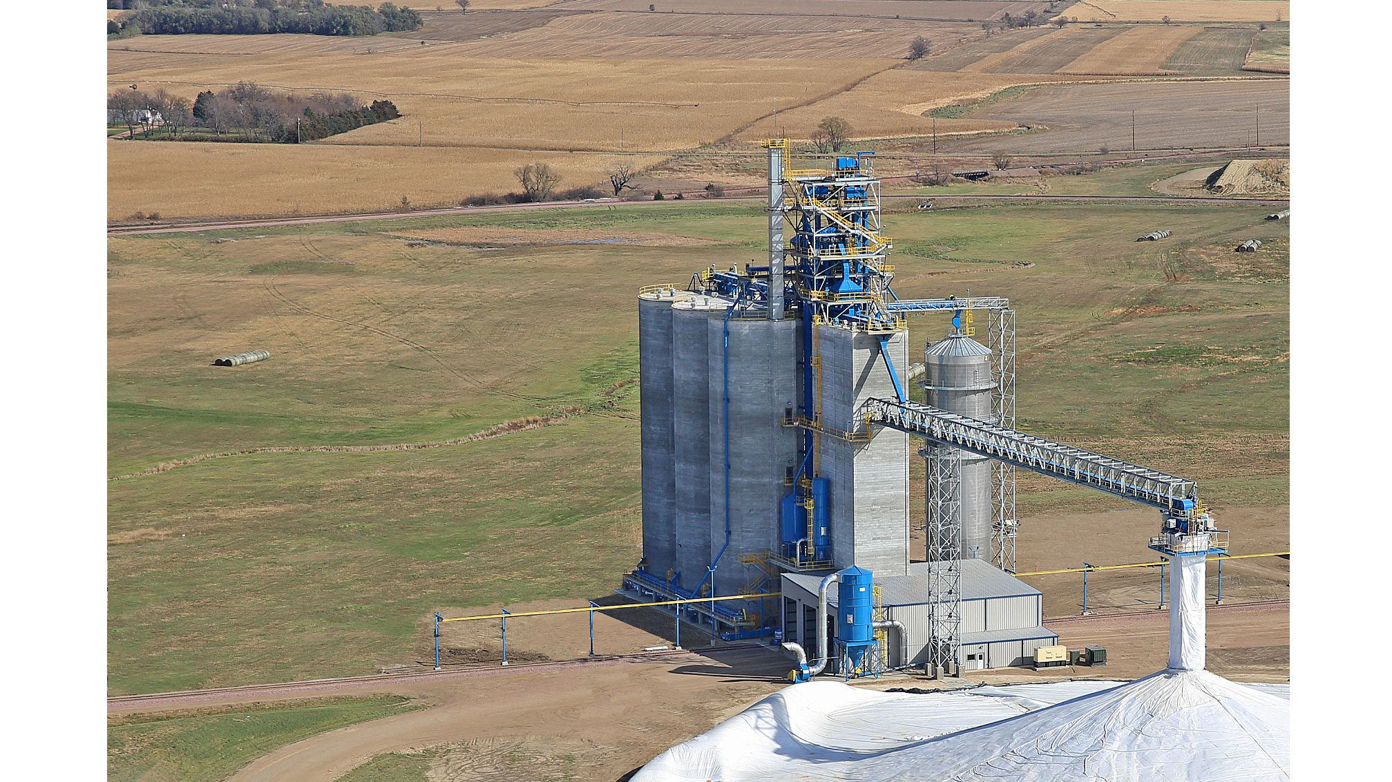 Industrial silo amidst open fields