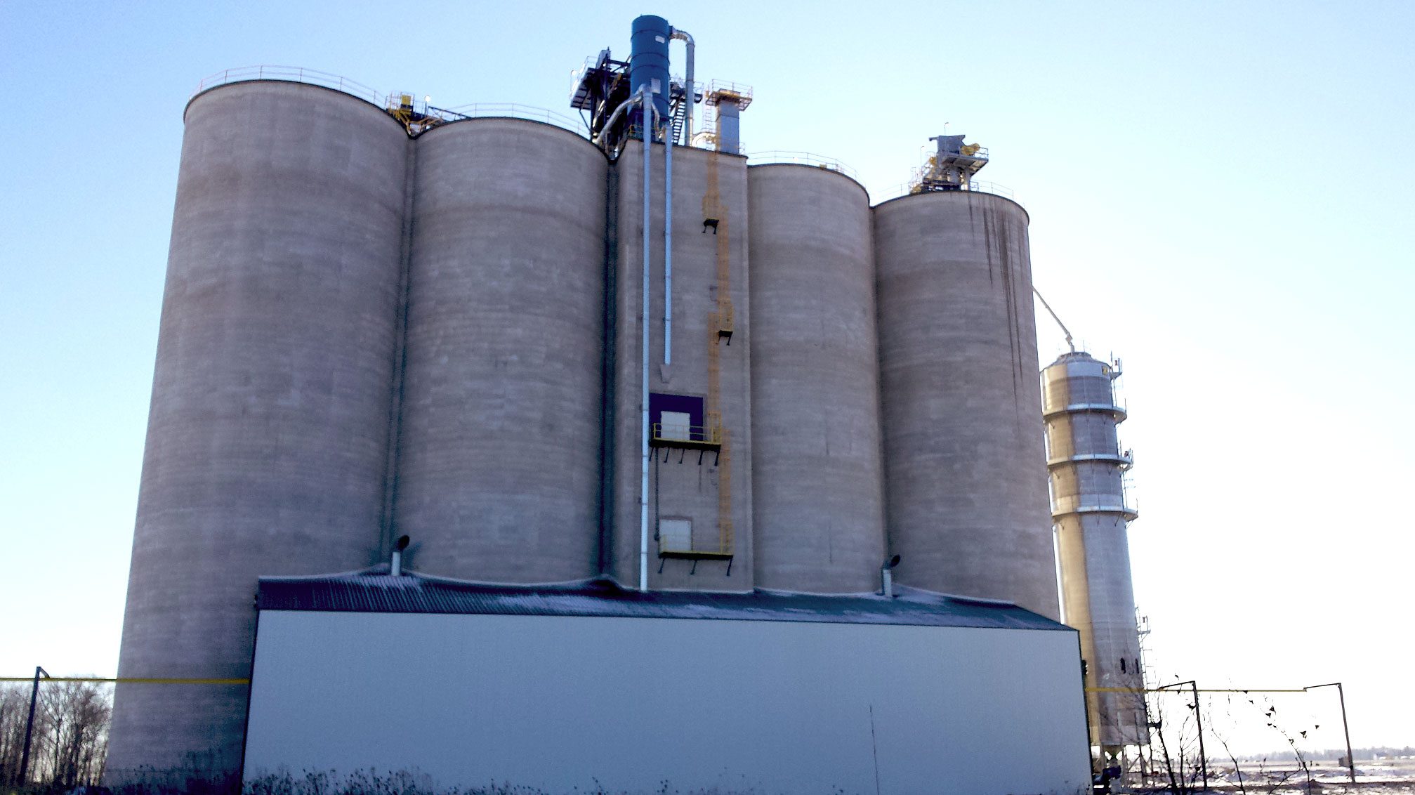 Concrete grain silos under clear sky