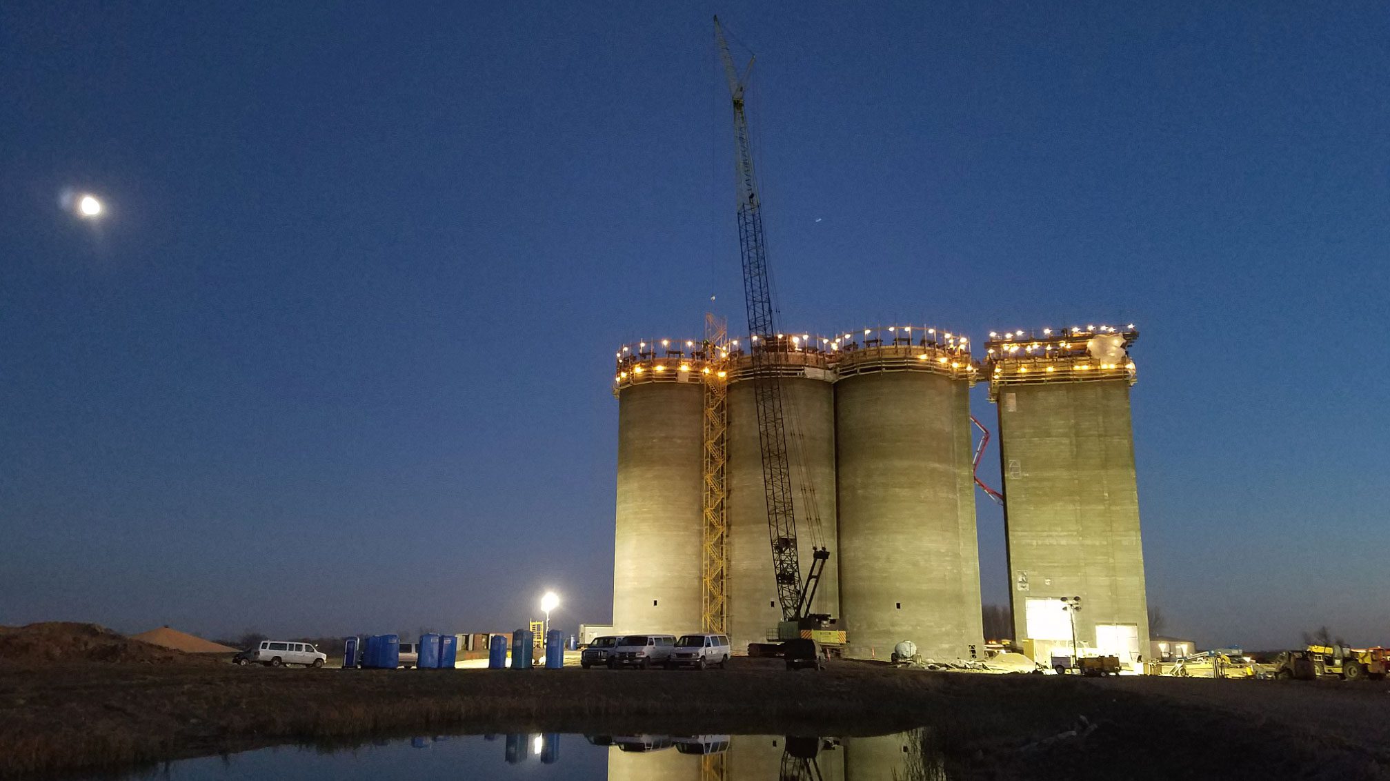 Nighttime view of silos and crane
